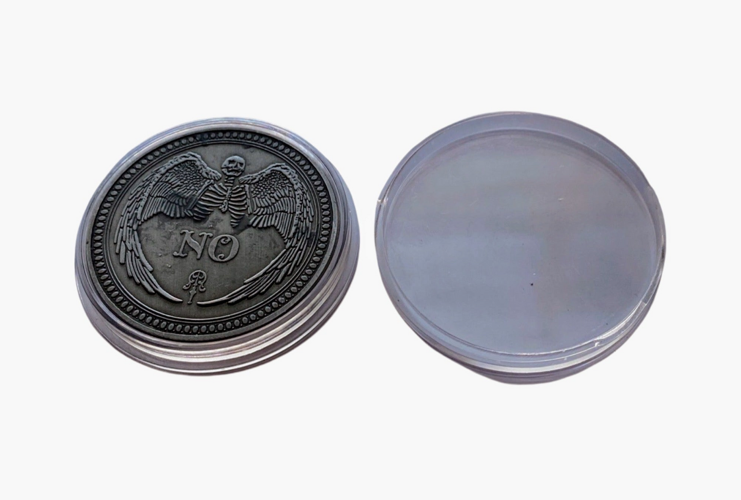 The No side of the Yes/No metal coin and clear plastic case. 

Each Destiny Decision Candle comes with a keepsake metal Yes/No flipping coin and plastic case.  