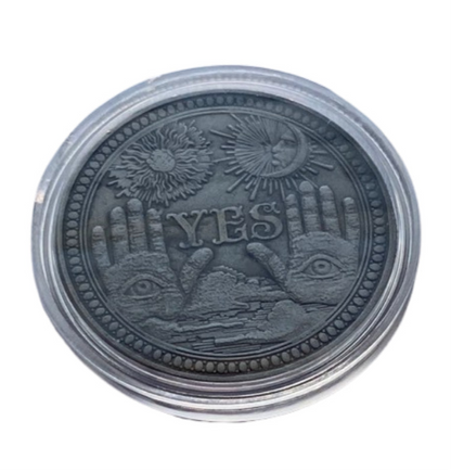 The Yes side of the Yes/No metal coin.  It is inside a round clear plastic case.  

Each Destiny Decision Candle comes with a keepsake metal Yes/No flipping coin and plastic case.  